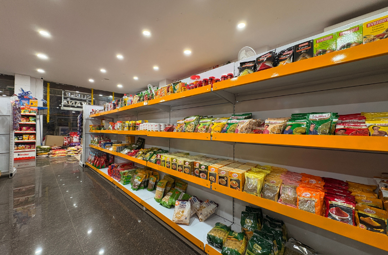 SuperKirana grocery shelves featuring neatly arranged daily essentials and packaged food items